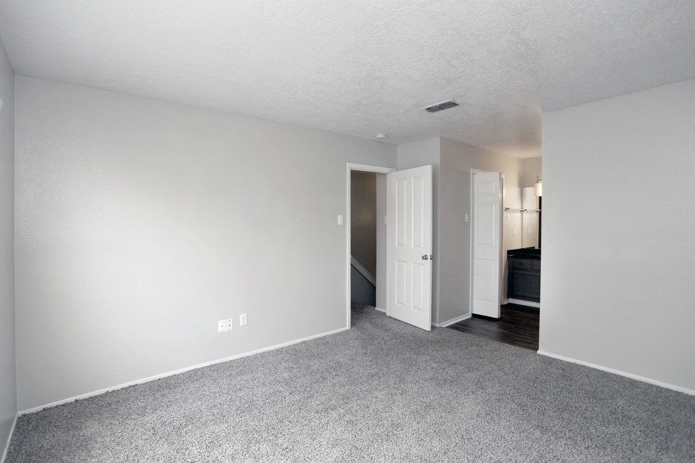A room with a carpeted floor and white walls.